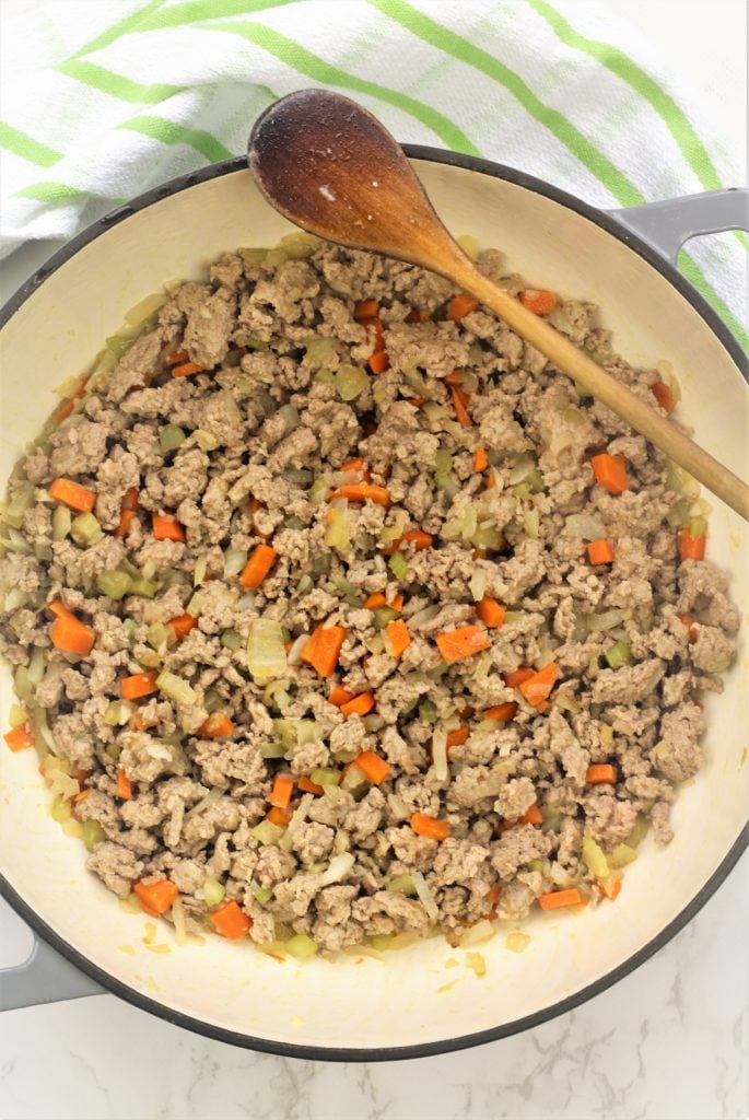 skillet with ground meat and carrot, onions and celery