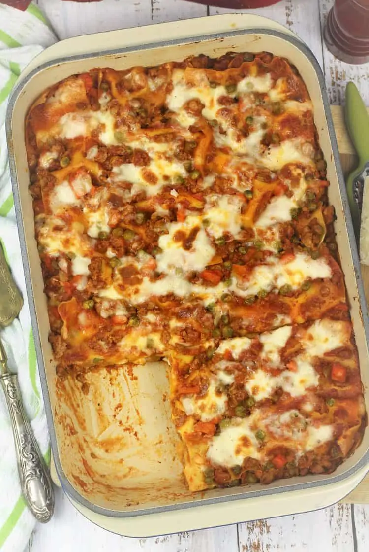 overhead view of sicilian lasagna in pan with slice cut out