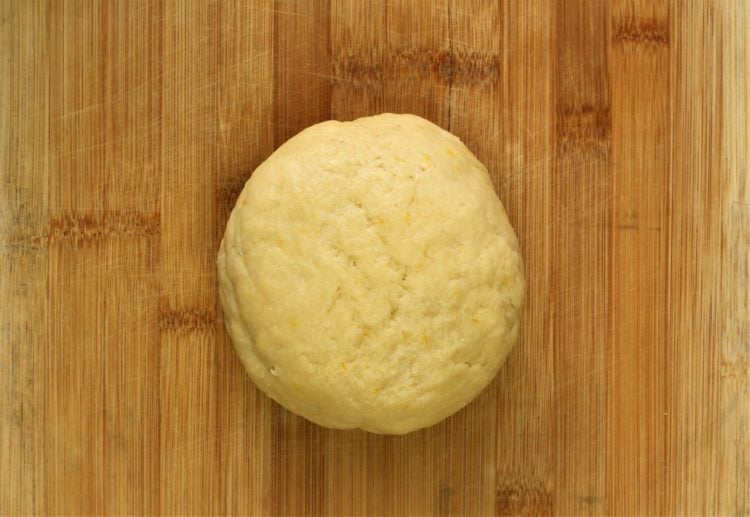 cookie dough shaped into a ball on wood boardBiscotti Regina - Sicilian Sesame Seed Cookies