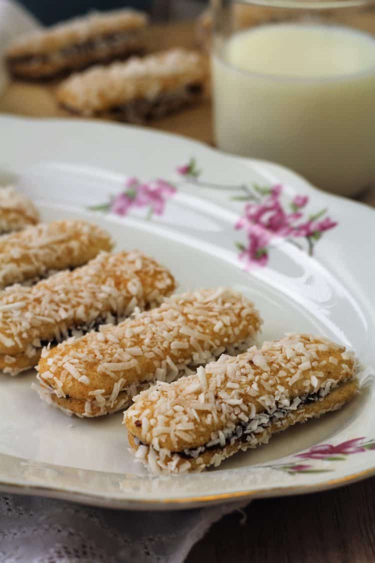 Nutella and Mascarpone filled Pavesini Cookies on serving plate with glass of milk