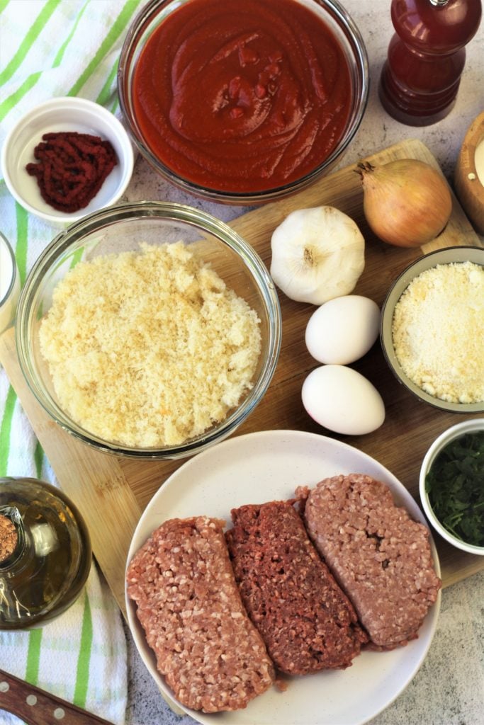 ingredients for meatballs with tomato sauce in bowls 