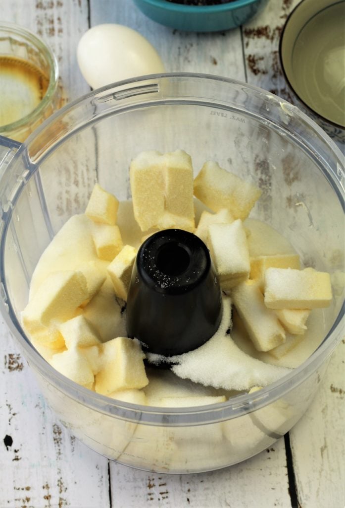 cubed butter and sugar in food processor bowl