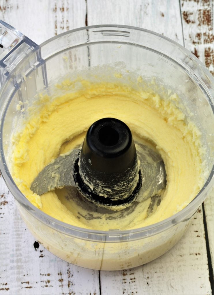creamed butter and sugar in food processor bowl with blade