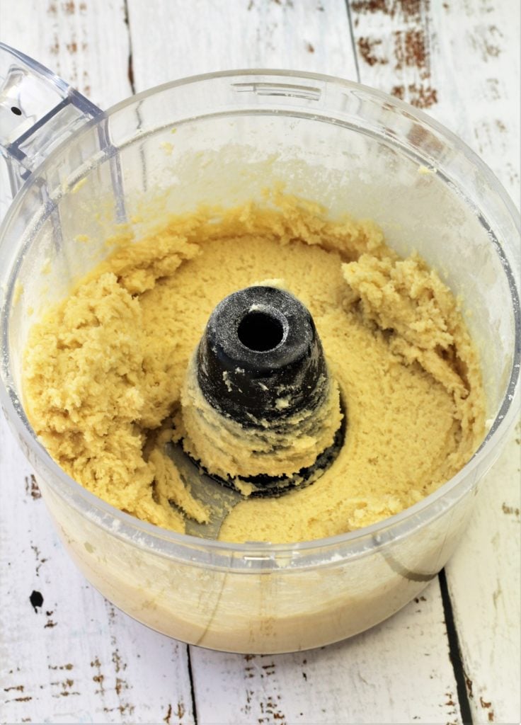 food processor bowl filled with creamy cookie dough