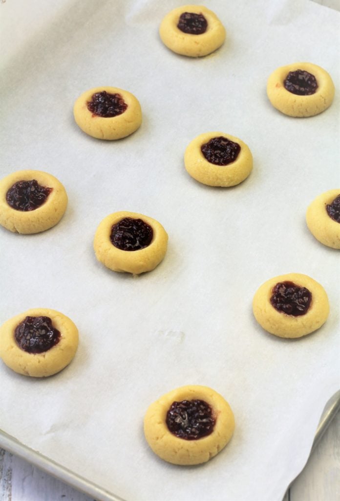 jam filled thumbprint cookies on baking sheet