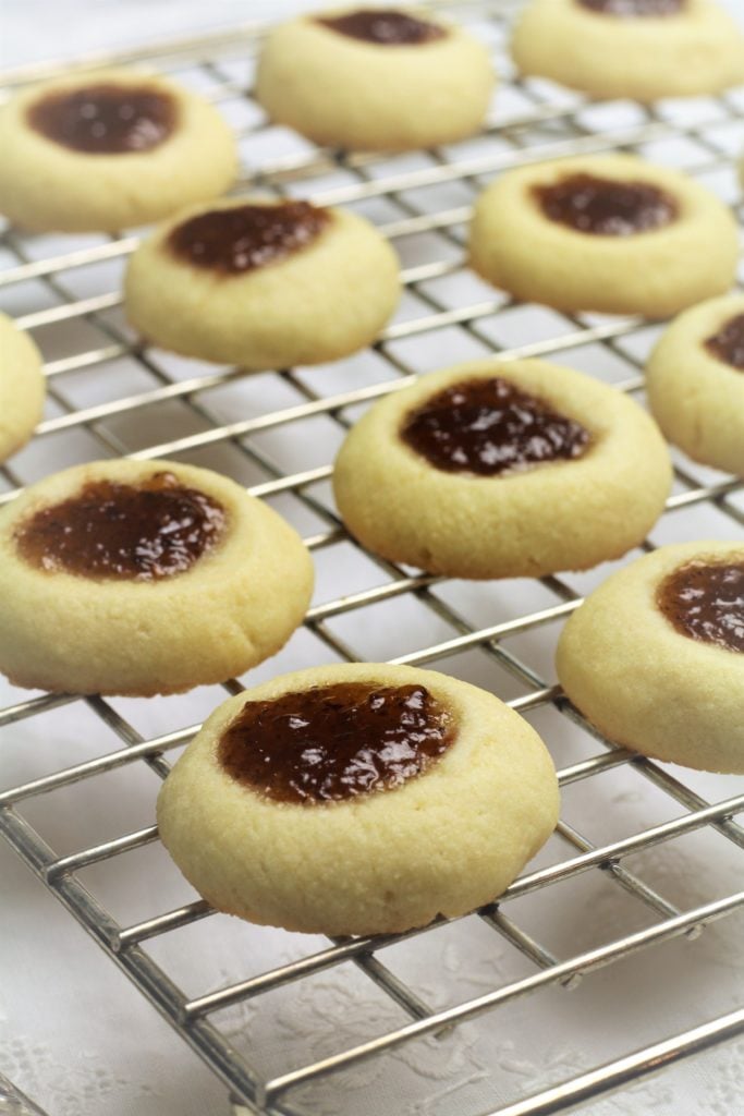 baked jam filled thumbprint cookies on wire rack