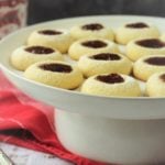 jam filled thumbprint cookies on round cake stand