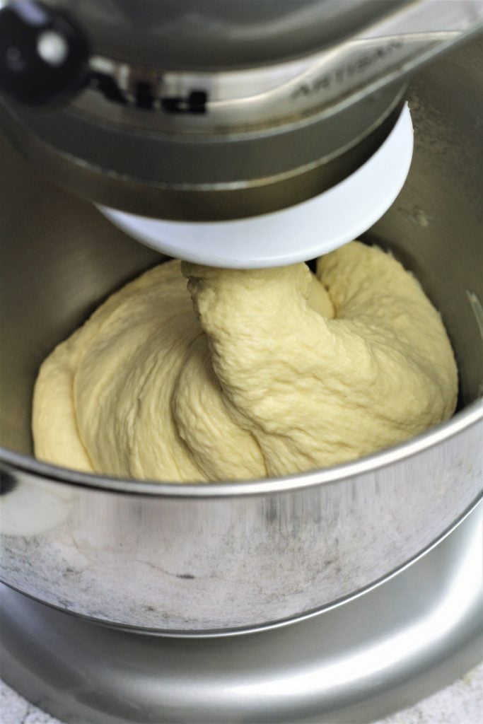 semolina bread dough in stand mixer wrapped around hook