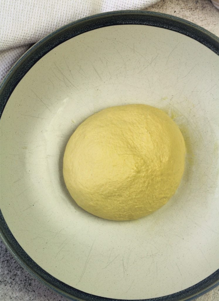semolina bread dough shaped as a ball in large bowl