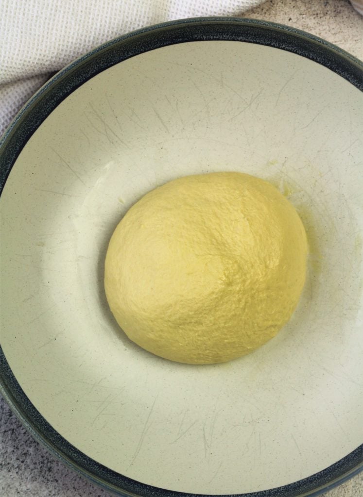 semolina bread dough shaped as a ball in large bowl
