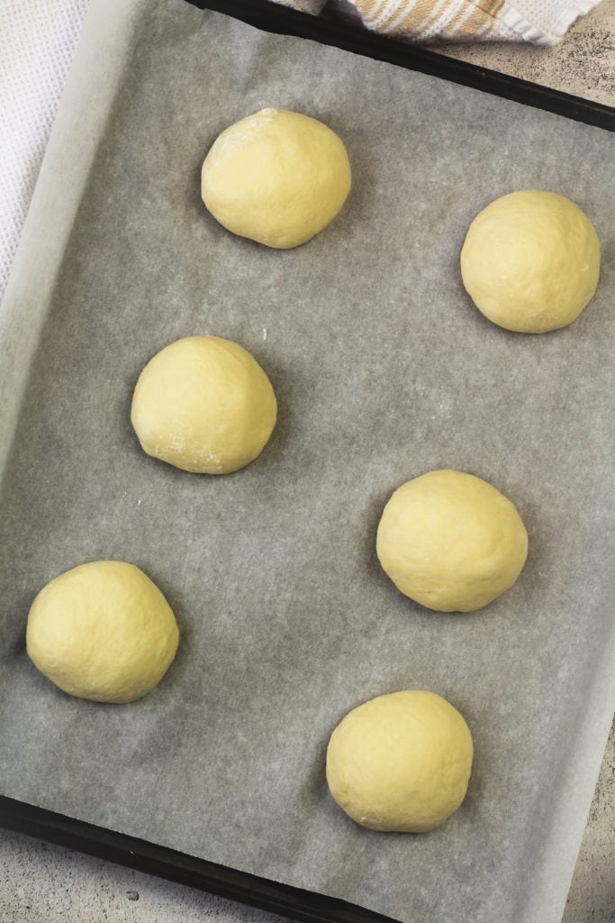 semolina dough balls on baking sheet