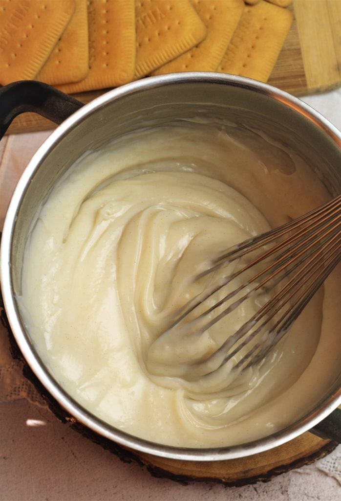 sauce pan with milk pudding being whisked