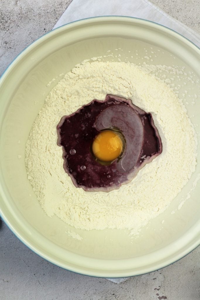 bowl with flour and egg, red wine mixture in the center