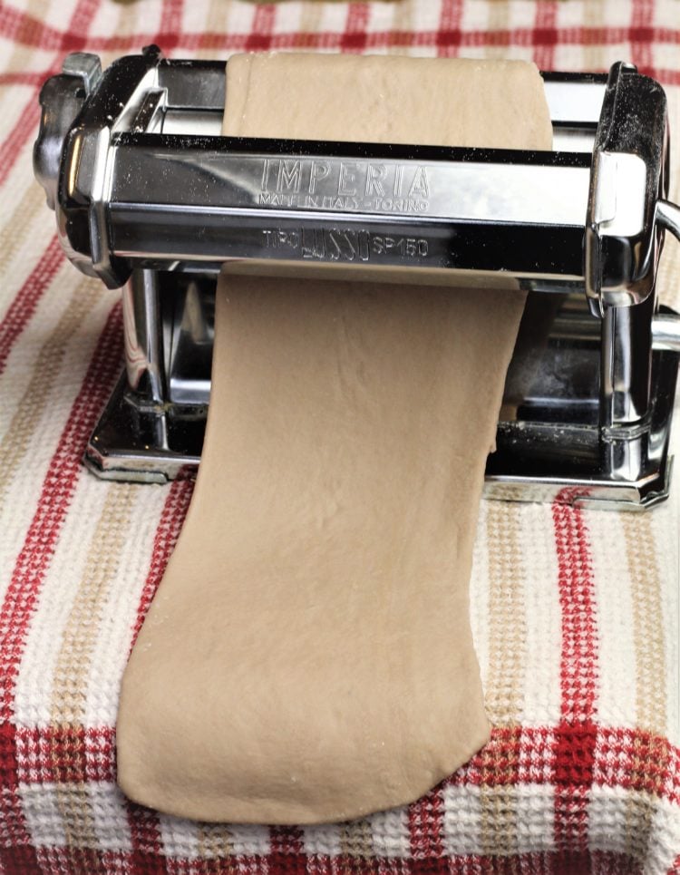 dough rolled through pasta rolling machine