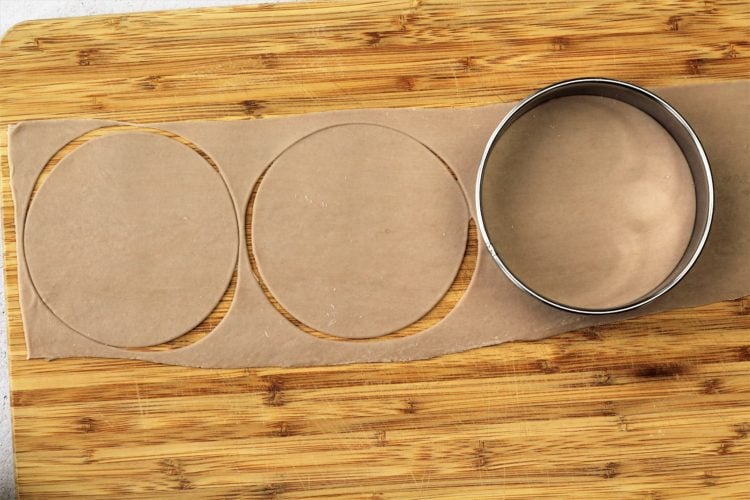 strips of dough cut into rounds with metal cookie cutter