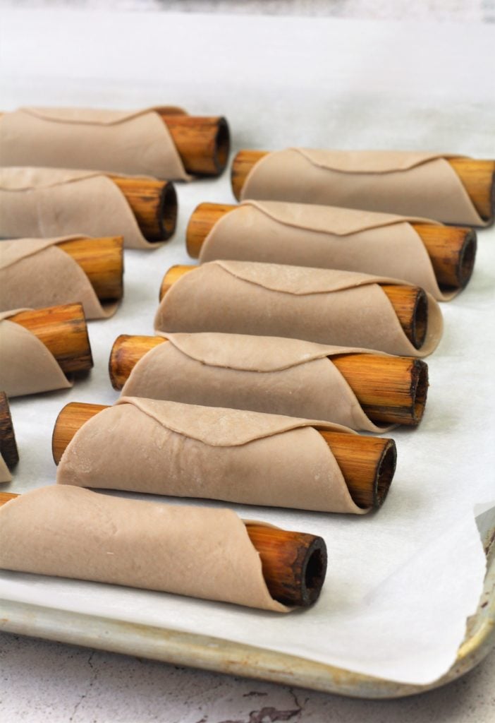 dough wrapped around cannoli bamboo molds