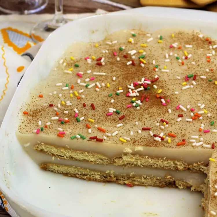 layered milk pudding and cookies in baking dish with candy sprinkles on top
