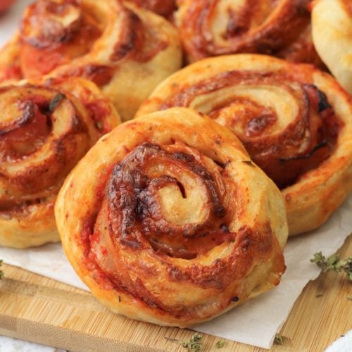 pizza roll up with ham and cheese on wood board
