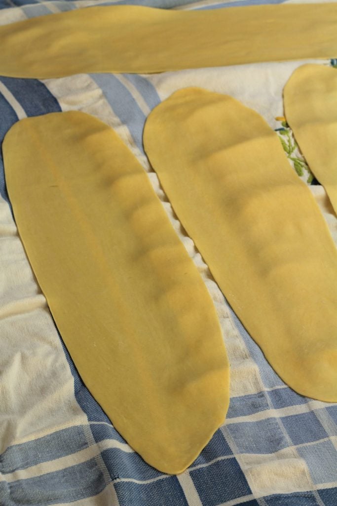 sheets of pasta dough on table cloth