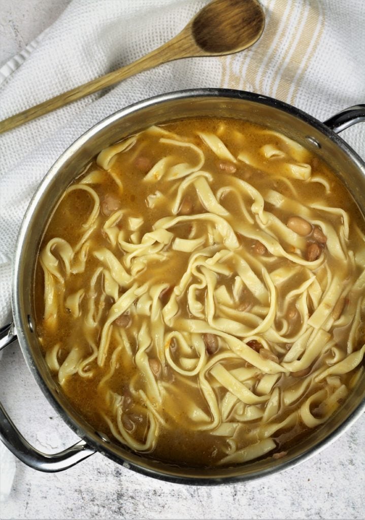large pot filled with tagliarini with beans 
