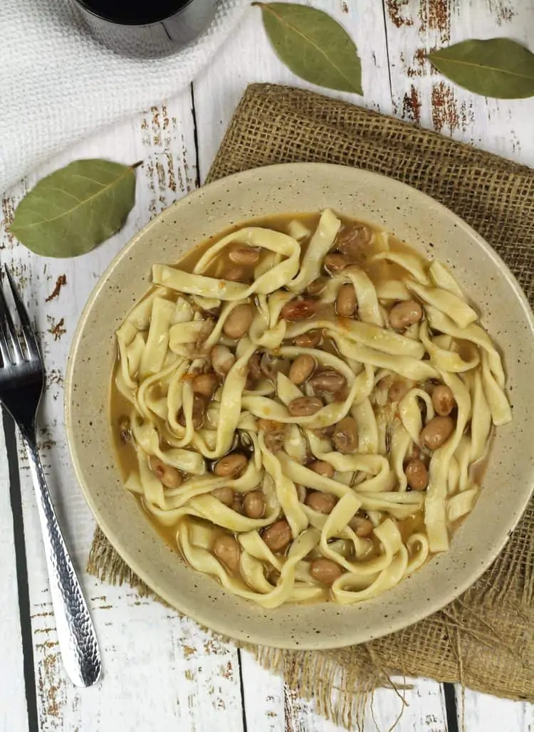 bowl of tagliarini pasta with beans