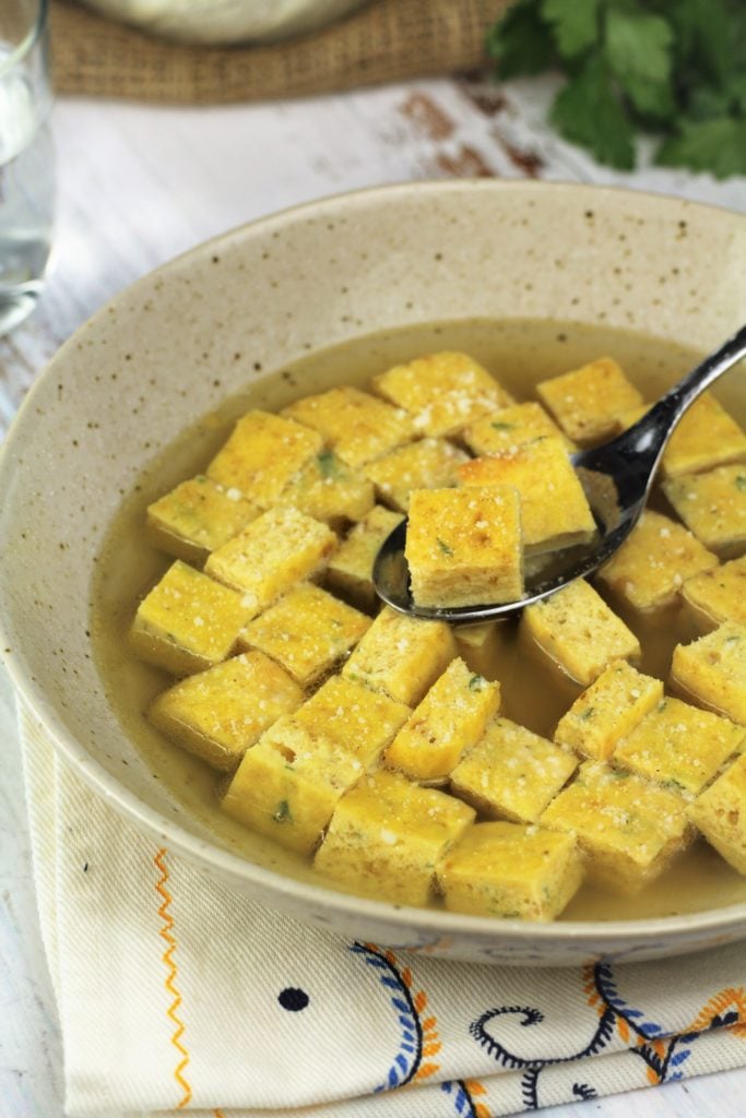 bowl of cubed frittata soup with spoonful