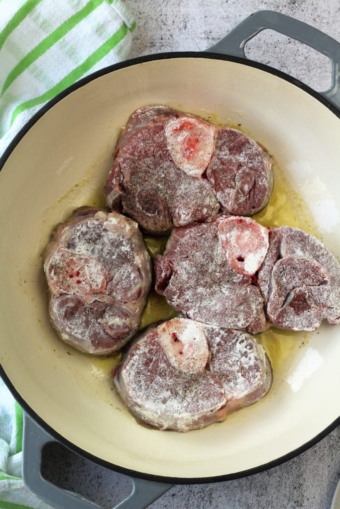 floured veal osso buco browning in skillet