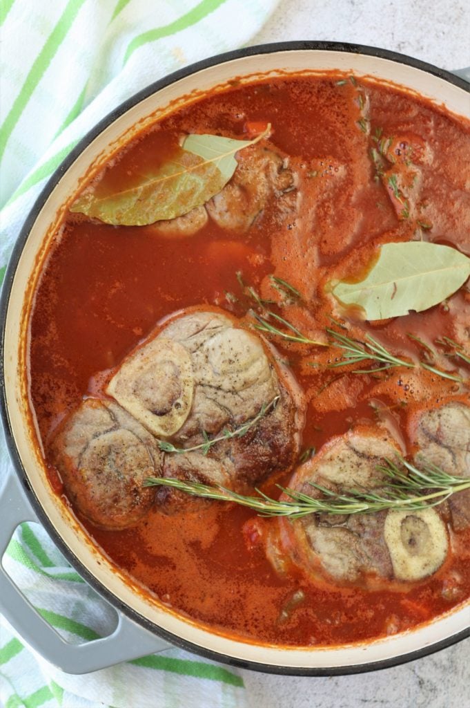 veal osso buco braised in tomato sauce in dutch oven