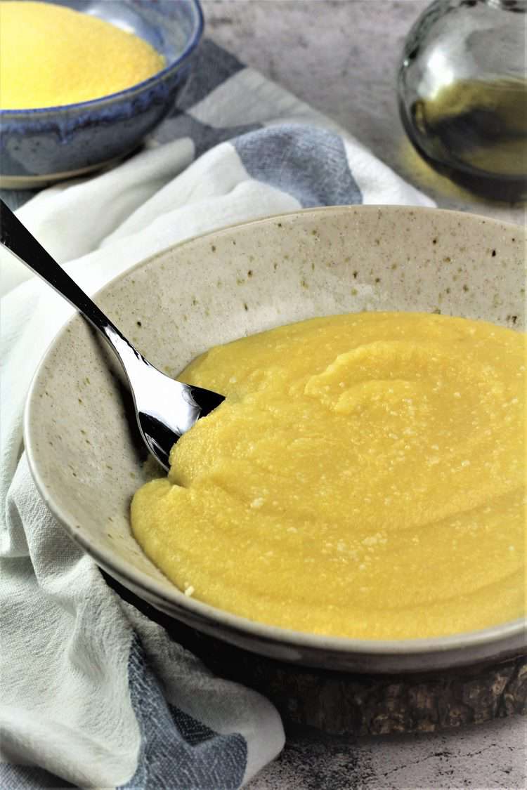 bowl of creamy polenta with spoon