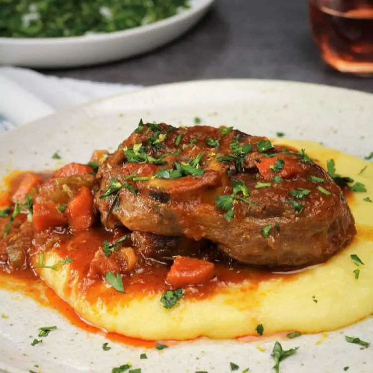 osso buco with sauce on bed of polenta