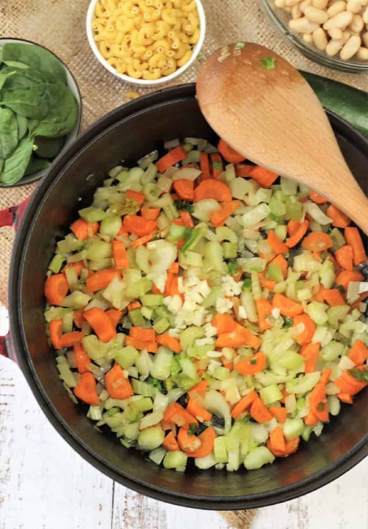 Carrots, celery, and onion sautéed in sauce pan for minestrone soup.