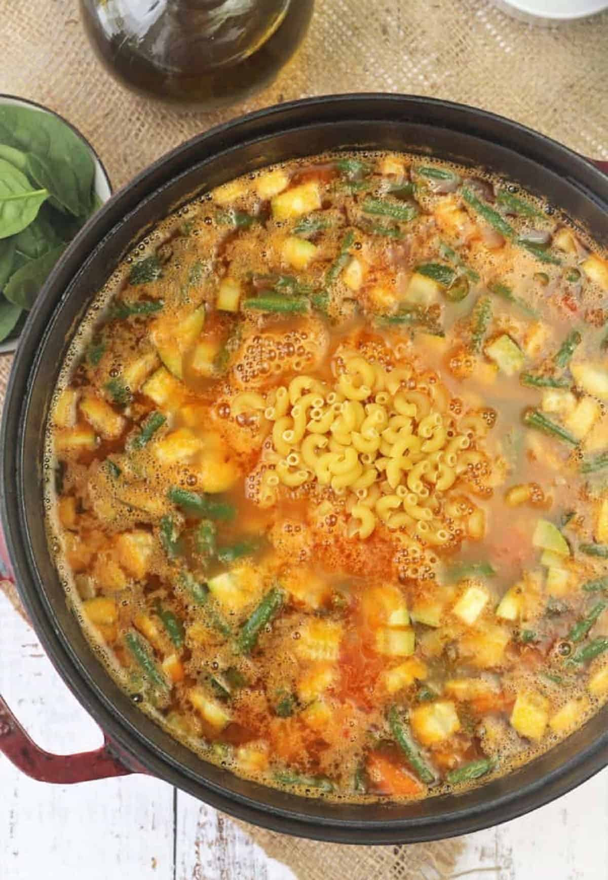 Pasta added to minestrone soup sauce pan.