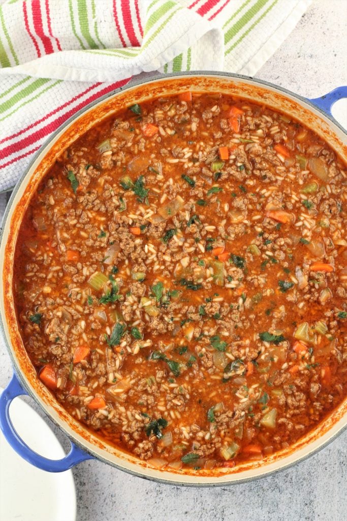 tomato sauce with beef and vegetables in blue skillet