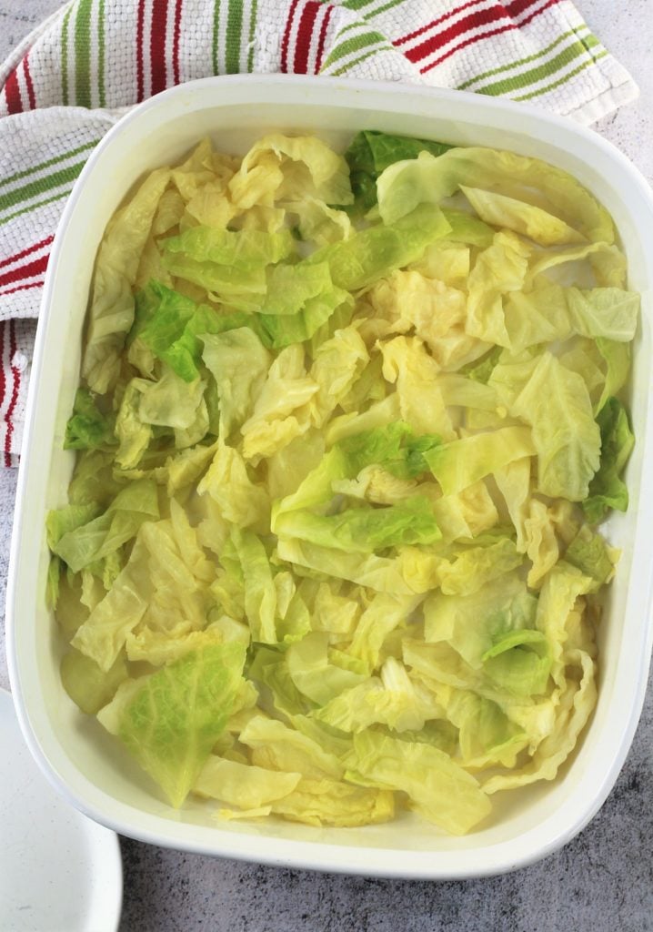 shredded cabbage on bottom of baking dish