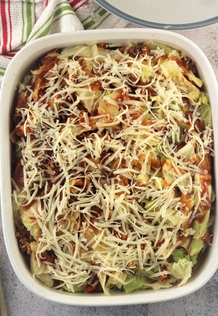 layered cabbage roll casserole in baking dish topped with mozzarella