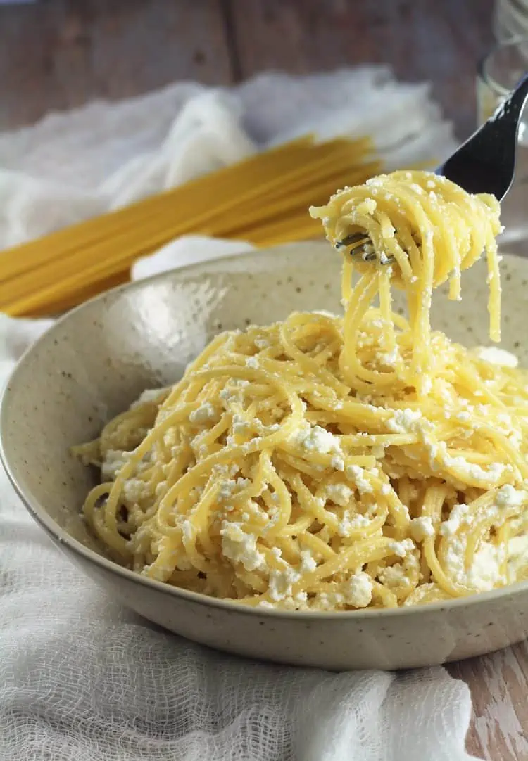 Bowl of spaghetti with ricotta with forkful.