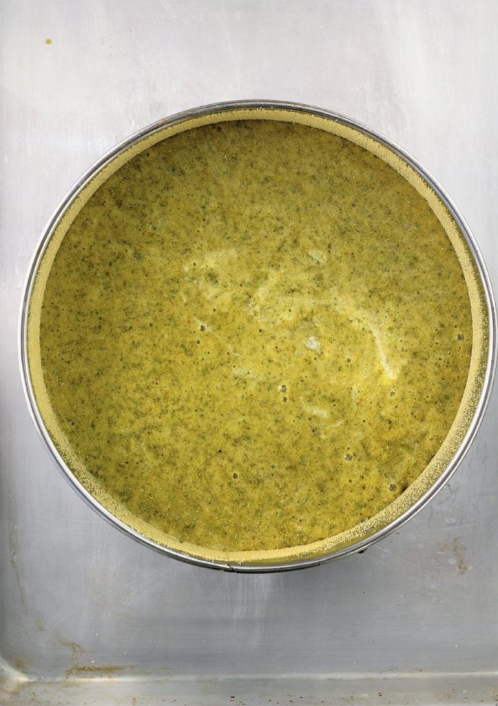 Pistachio cake batter in spring form pan.
