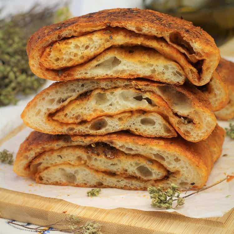 Wedges or rolled herb bread with garlic stacked.