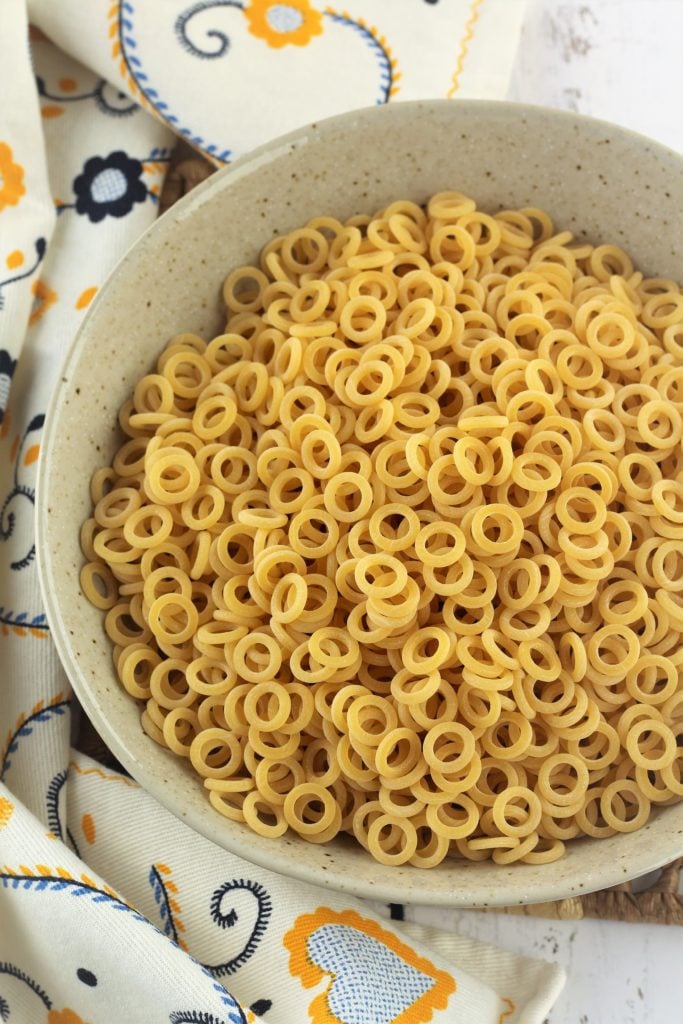 Ring shaped anelletti pasta in bowl.