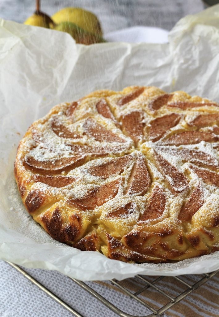 Pear and ricotta cake dusted with powdered sugar.