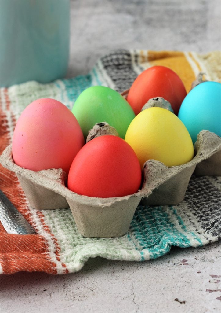 Dyed Easter eggs in egg carton.