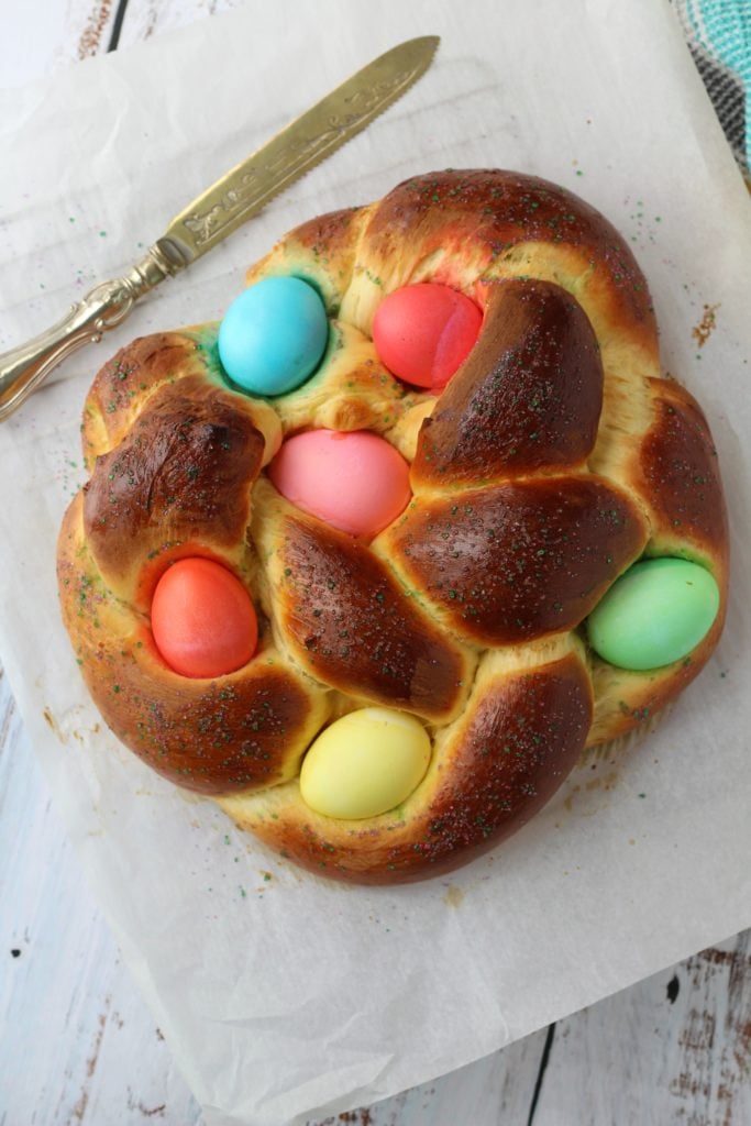 Sweet Italian Easter bread with colored eggs and sprinkles.