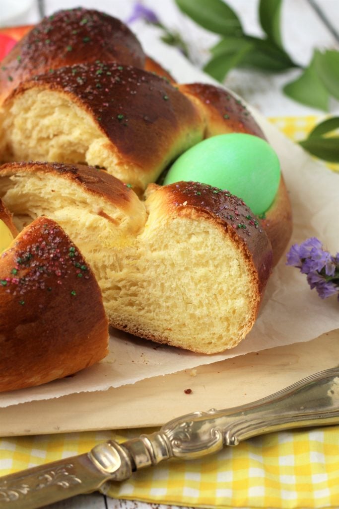 Sliced Italian Easter bread with dyed eggs.