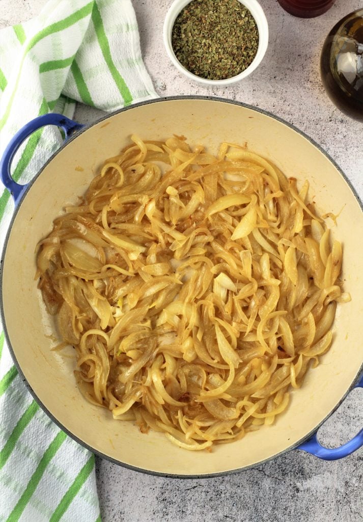 Skillet filled with sautéed onions.