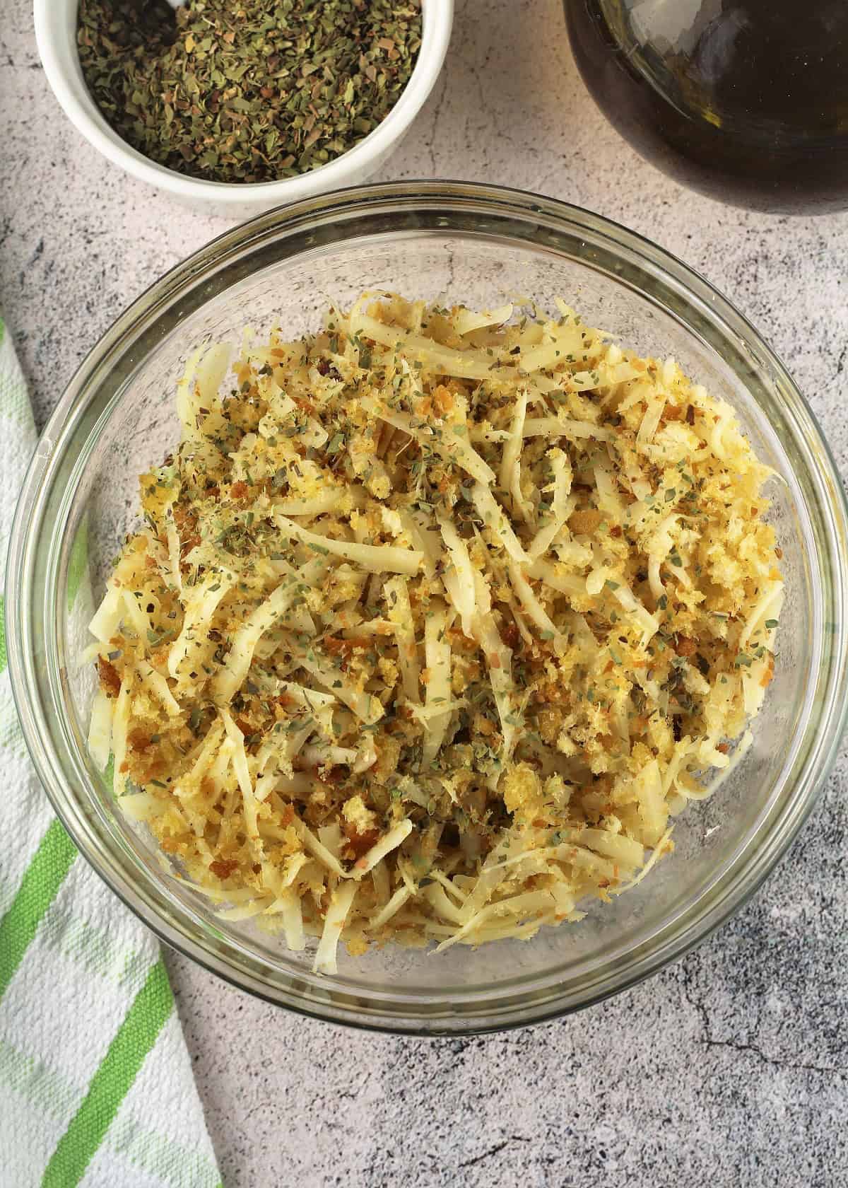 Onion and toasted muddica topping for sfincione in glass bowl.