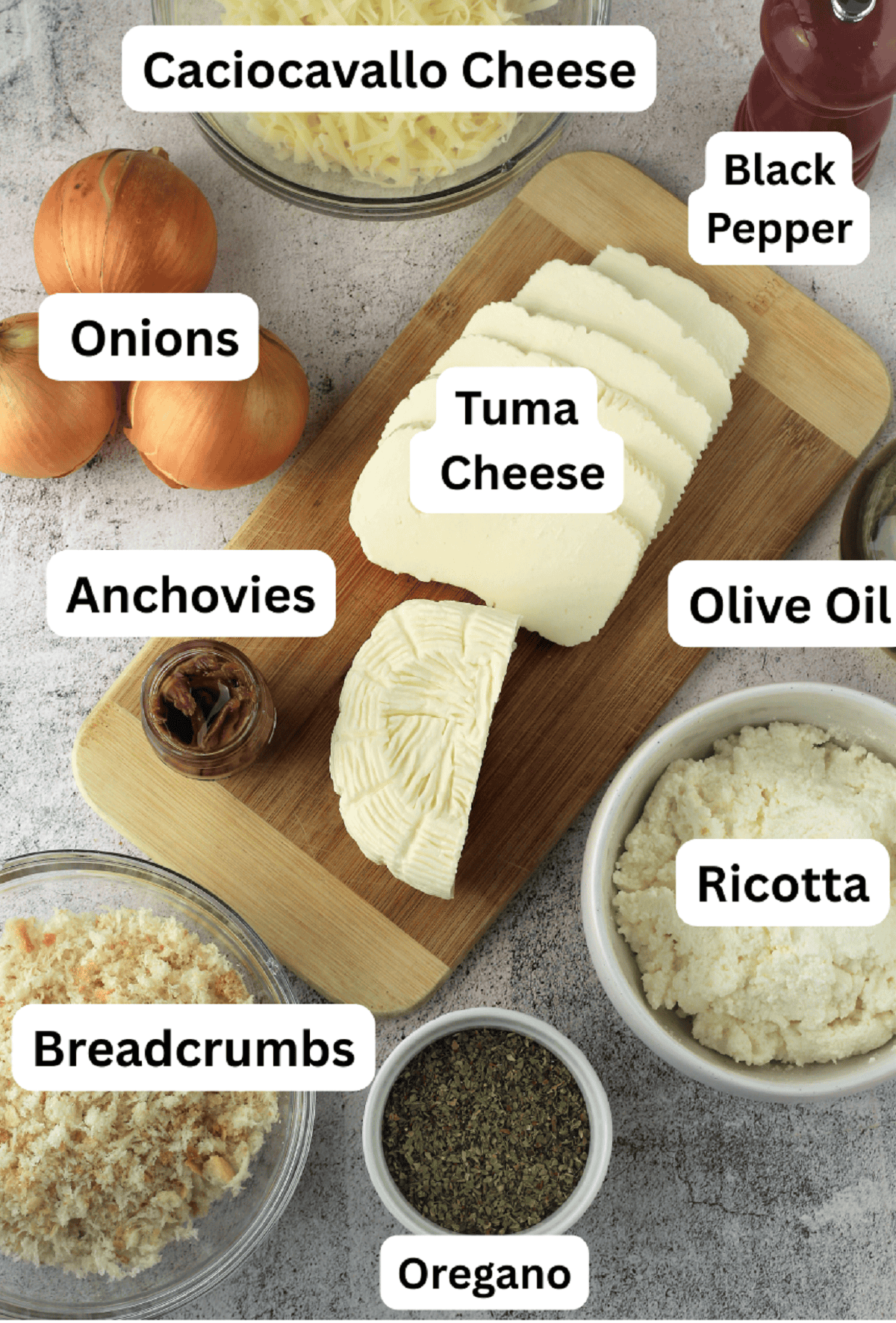 Tuma, caciocavallo, ricotta cheeses, oregano, breadcrumbs, anchovies, onions and black pepper.
