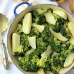 Blue skillet filled with broccoli and potatoes.