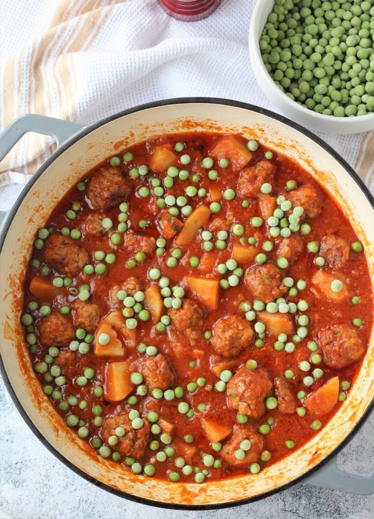 Meatball stew with peas stirred in.