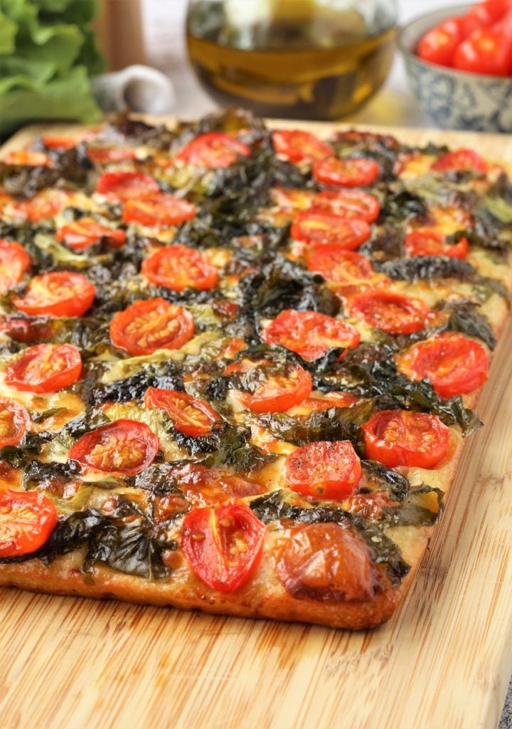 Just baked focaccia messinese on wood board.