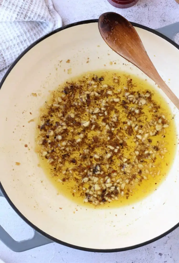 Anchovy and garlic sauce for pasta in large pan.